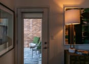 Thumbnail 32 of 75 - a glass door looking out onto a patio from indoors at The Apex at CityPlace, Overland Park, 66210