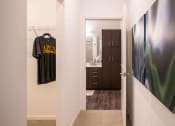 Thumbnail 39 of 75 - hallway with a view inside an open closet and bathroom door at The Apex at CityPlace, Overland Park
