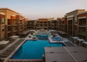 Thumbnail 58 of 75 - aerial view of apartment complex with a pool and outdoor seating in the center at The Apex at CityPlace, Kansas, 66210
