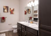 Thumbnail 9 of 34 - A full bathroom with double-vanity at Aspen Ridge 55+ Apartment Community in Olathe, KS