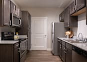 Thumbnail 12 of 34 - A fully-equipped kitchen at Aspen Ridge 55+ Apartment Community in Olathe, KS.