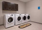 Thumbnail 28 of 34 - A community laundry room with four machines at Aspen Ridge 55+ Active Adult Community