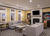 Thumbnail 32 of 34 - A reading nook with couches and chairs and a fireplace at Aspen Ridge 55+ Active Adult Community