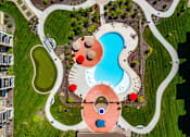 Thumbnail 5 of 34 - Putting Green, Swimming Pool, Grilling Stations, and Walking Trails at Aspen Ridge 55+ Apartment Community in Olathe, KS