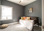 Thumbnail 7 of 18 - A bedroom with a bed, pillows, and a window.