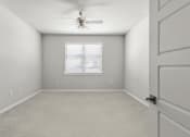 Thumbnail 7 of 36 - an empty room with a ceiling fan and a window at Hillcrest Village, Arkansas, 72762