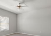 Thumbnail 9 of 36 - an empty room with a ceiling fan and a window at Hillcrest Village, Springdale, AR