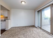 Thumbnail 5 of 19 - A room with a carpeted floor and sliding glass doors.