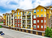 Thumbnail 44 of 59 - A large apartment building with multiple balconies and garages.