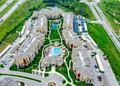 Thumbnail 46 of 59 - A bird's eye view of a residential complex with a swimming pool.