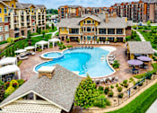 Thumbnail 6 of 59 - A large house with a pool in the middle of it.