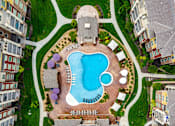 Thumbnail 5 of 59 - An aerial view of a swimming pool surrounded by buildings.
