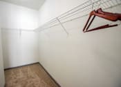 Thumbnail 41 of 50 - A white wall with a brown carpet and a clothes hanger.
