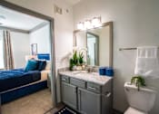 Thumbnail 38 of 50 - A bathroom with a blue bed and a white toilet.