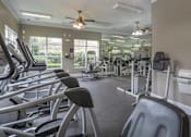Thumbnail 11 of 50 - A gym with treadmills, elliptical machines, and other exercise equipment.