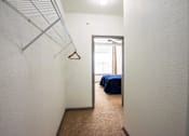 Thumbnail 40 of 50 - A room with a bed and a hanger on the wall.