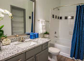 Thumbnail 35 of 50 - A bathroom with a sink, toilet, and shower.