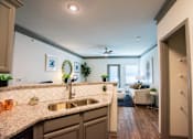 Thumbnail 3 of 50 - A kitchen with a sink and a counter.