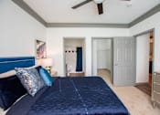 Thumbnail 34 of 50 - A bedroom with a bed, dresser, and ceiling fan.