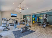 Thumbnail 21 of 34 - A spacious home gym with a variety of exercise equipment.