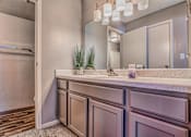 Thumbnail 4 of 34 - A bathroom with a vanity and a mirror.