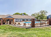 Thumbnail 8 of 34 - A house with a pool and a covered patio.