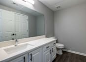 Thumbnail 18 of 28 - A bathroom with a white sink and toilet.