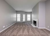 Thumbnail 26 of 28 - A room with a fireplace and carpeted floor.