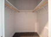 Thumbnail 7 of 18 - A white room with a brown carpet and white walls.