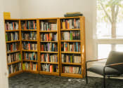 Thumbnail 9 of 23 - a chair and bookcase in a room