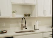 Thumbnail 6 of 23 - a kitchen sink with a chrome faucet