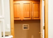 Thumbnail 20 of 23 - a kitchen with white appliances and wooden cabinets
