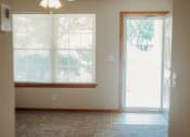 Thumbnail 17 of 23 - an empty room with a door and a window