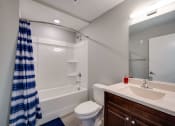 Thumbnail 14 of 15 - a bathroom with a shower toilet and sink and a mirror
