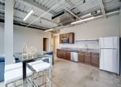Thumbnail 13 of 15 - a kitchen with white appliances and a glass table