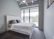 Thumbnail 15 of 15 - a bedroom with a white bed and a large window