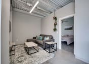 Thumbnail 9 of 15 - a living room with a couch and a table     and a bedroom