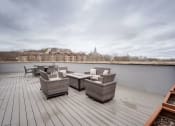 Thumbnail 3 of 15 - the deck has a view of the river and a patio with chairs and tables