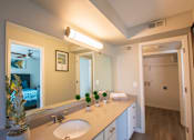 Thumbnail 21 of 25 - A bathroom with a pineapple on the counter.