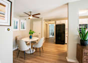 Thumbnail 7 of 25 - A dining room with a white table and chairs.