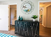 Thumbnail 9 of 25 - A black cabinet with white lines and a plant on top.