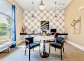 Thumbnail 21 of 50 - A dining room with a table and chairs.