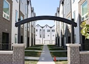 Thumbnail 16 of 18 - A row of modern houses with a black archway in the foreground.