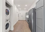 Thumbnail 15 of 15 - A laundry room with a washer and dryer in it.