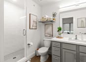 Thumbnail 6 of 12 - A white bathroom with a toilet, sink, and mirror.