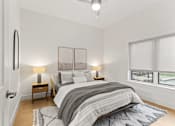 Thumbnail 9 of 12 - A bedroom with a large bed and two lamps.