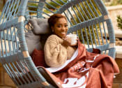 Thumbnail 39 of 50 - Girl sitting in egg chair with coffee mug at The Residences at Galleria, Kansas