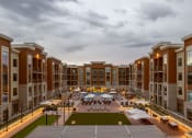 Thumbnail 21 of 50 - Sunset with perfect lighting at outdoor gaming terrace, pool deck, and grills at The Residences at Galleria, Overland Park, KS