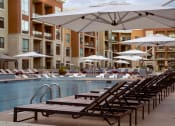 Thumbnail 41 of 50 - Pool deck with ample seating for sunbathing at The Residences at Galleria, Overland Park, Kansas