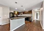 Thumbnail 29 of 42 - A Kitchen With a Refrigerator at Capitol Grove Apartments, Des Moines, 50317
